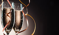 Elegant image closeup of two champagne glasses and decorative ribbons